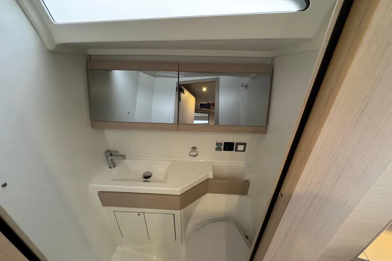  Yacht Photos Pics 2024 Beneteau Oceanis 46.1 yacht bathroom with modern sink and mirror design.