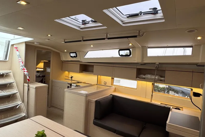  Yacht Photos Pics 2024 Beneteau Oceanis 46.1 yacht interior with modern kitchen and seating area.