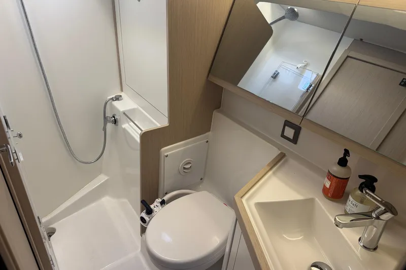  Yacht Photos Pics 2024 Beneteau Oceanis 46.1 yacht bathroom with shower, sink, and toilet.