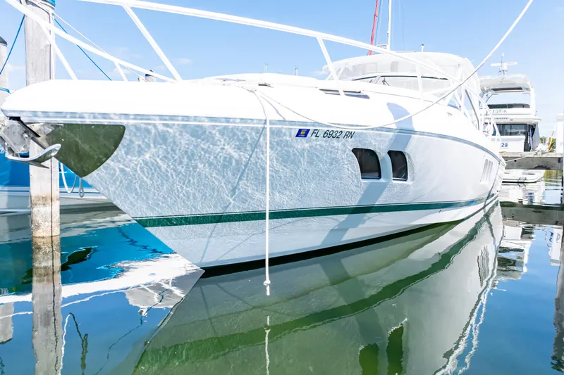  Yacht Photos Pics 2018 Intrepid 475 Sport Yacht docked, reflecting on calm water.