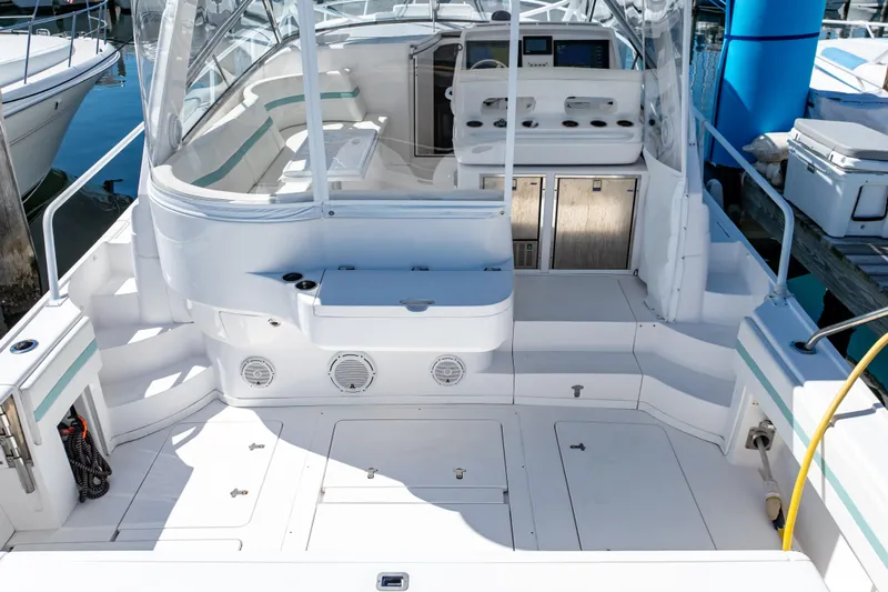  Yacht Photos Pics 2018 Intrepid 475 Sport Yacht cockpit with seating and control panel, docked at marina.