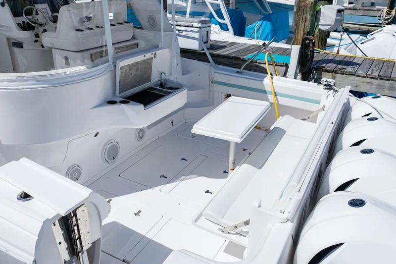  Yacht Photos Pics 2018 Intrepid 475 Sport Yacht deck with seating, table, and sink at marina.
