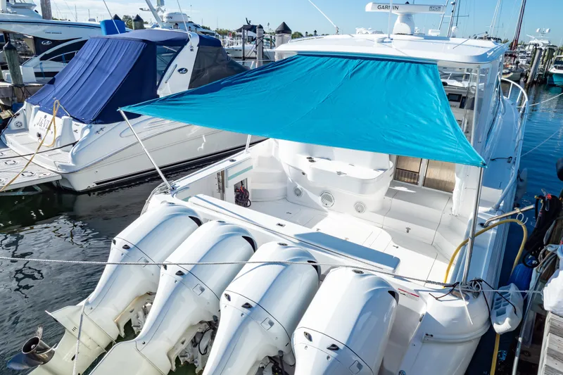  Yacht Photos Pics 2018 Intrepid 475 Sport Yacht docked with blue sunshade and multiple outboard engines.