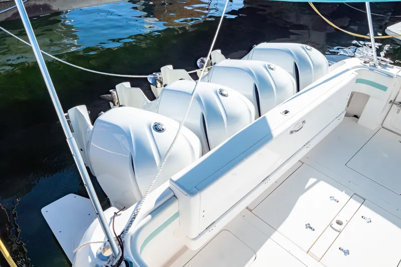  Yacht Photos Pics 2018 Intrepid 475 Sport Yacht with multiple outboard engines, docked on calm water.