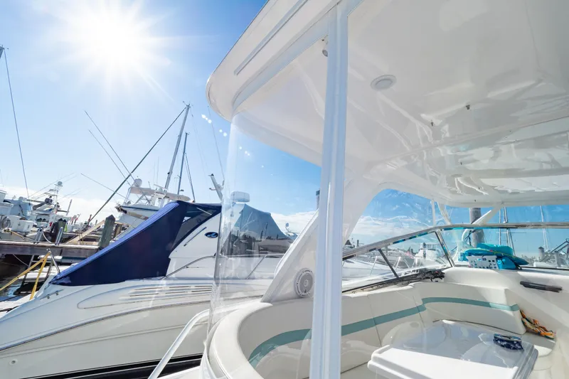  Yacht Photos Pics 2018 Intrepid 475 Sport Yacht docked under bright sun, showcasing sleek design and spacious deck.