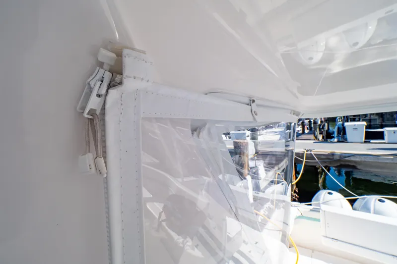  Yacht Photos Pics 2018 Intrepid 475 Sport Yacht with clear enclosure and dock view.