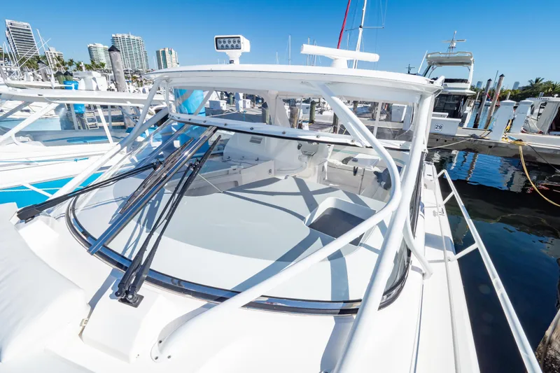 Yacht Photos Pics 2018 Intrepid 475 Sport Yacht docked at marina under clear blue sky.