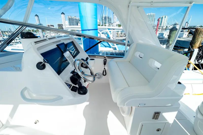  Yacht Photos Pics Helm of 2018 Intrepid 475 Sport Yacht with modern controls and white seating.