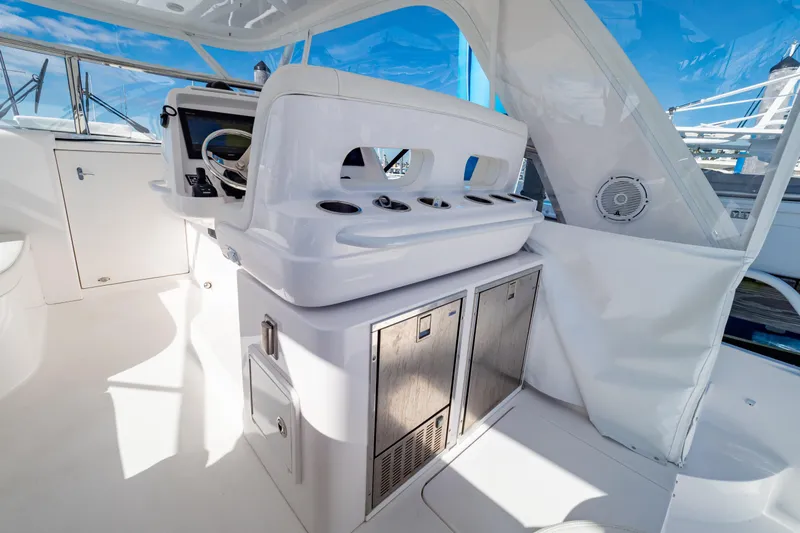  Yacht Photos Pics 2018 Intrepid 475 Sport Yacht interior with helm station and storage cabinets.