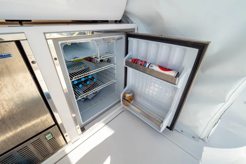  Yacht Photos Pics Open mini fridge on 2018 Intrepid 475 Sport Yacht, stocked with drinks and snacks.