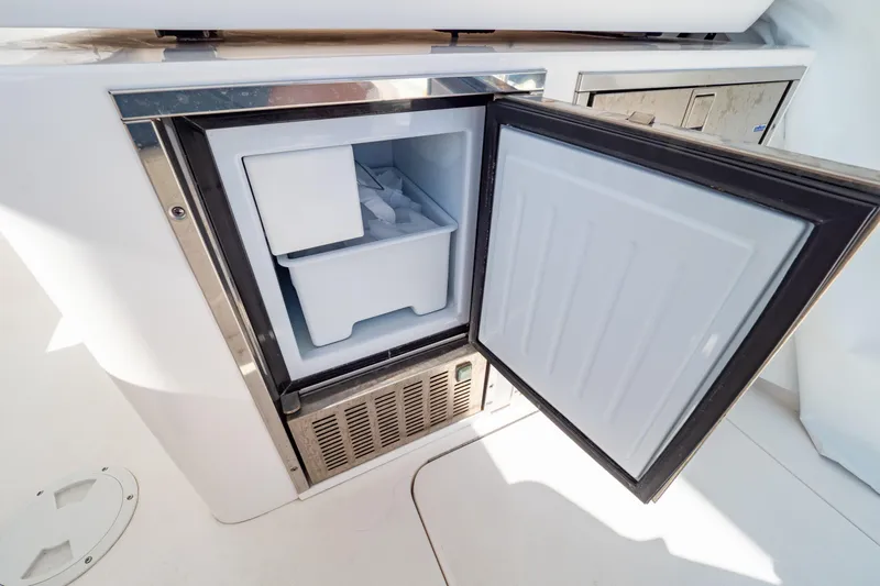  Yacht Photos Pics Open freezer compartment on 2018 Intrepid 475 Sport Yacht, showcasing interior storage space.