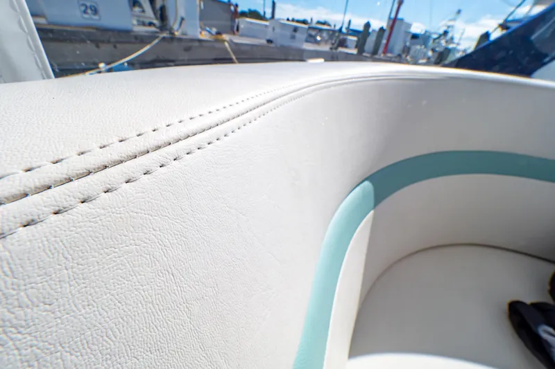  Yacht Photos Pics Close-up of 2018 Intrepid 475 Sport Yacht's white leather seating with teal accents.