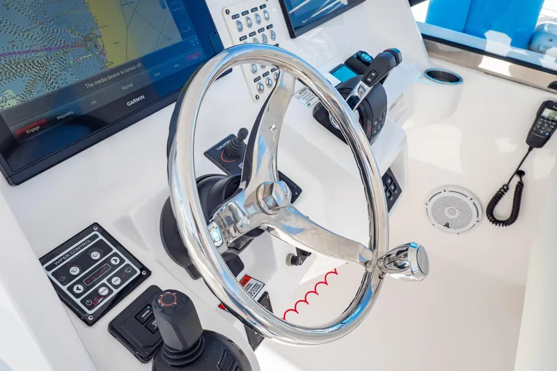  Yacht Photos Pics 2018 Intrepid 475 Sport Yacht helm with steering wheel and navigation controls.