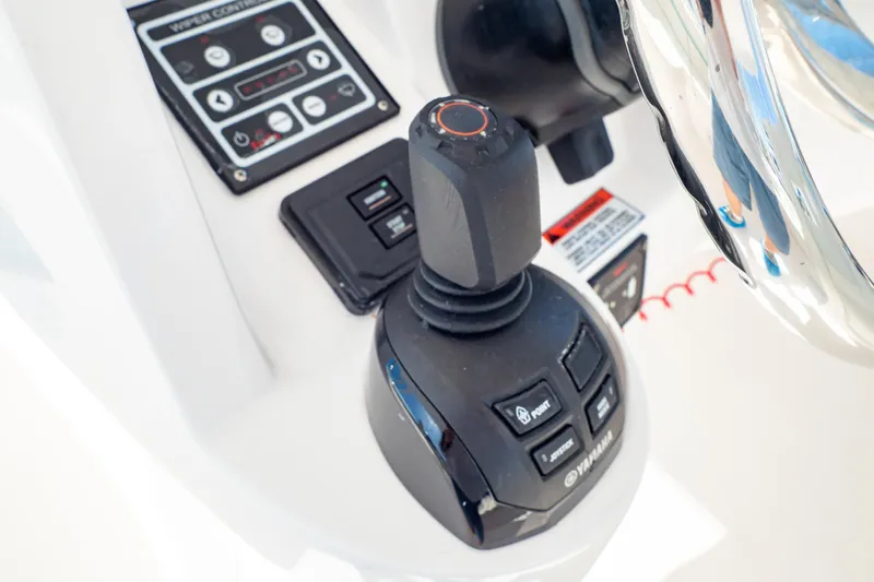  Yacht Photos Pics Control panel of a 2018 Intrepid 475 Sport Yacht with joystick and steering wheel.