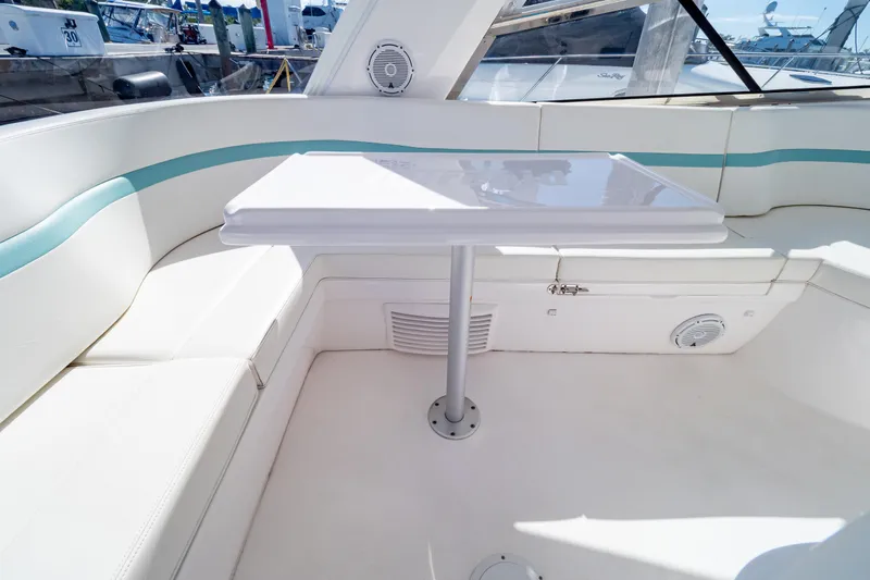  Yacht Photos Pics 2018 Intrepid 475 Sport Yacht interior with white seating and table.