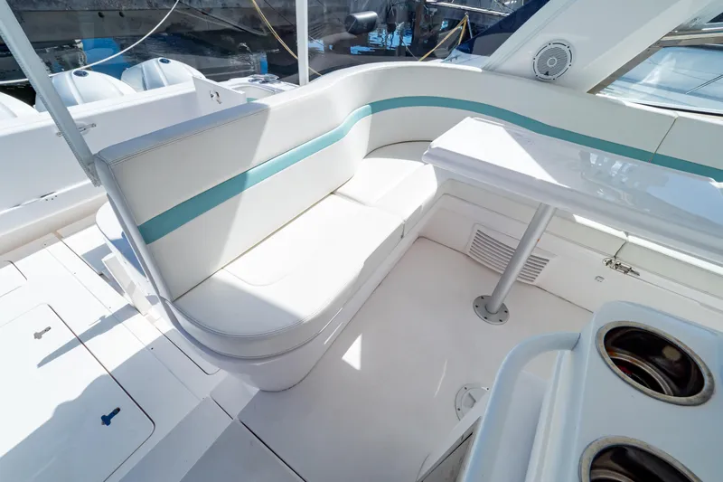  Yacht Photos Pics Luxurious seating area on a 2018 Intrepid 475 Sport Yacht, featuring white and teal upholstery.