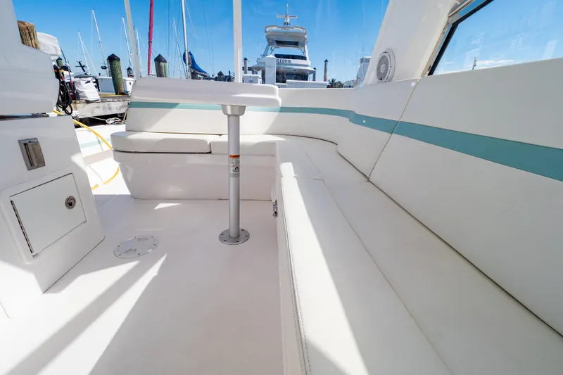  Yacht Photos Pics Interior view of 2018 Intrepid 475 Sport Yacht with white seating and table.