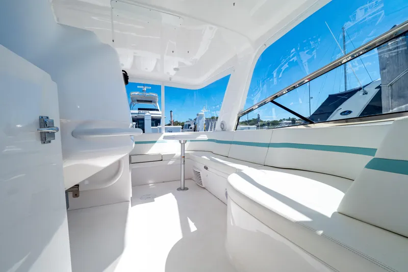  Yacht Photos Pics 2018 Intrepid 475 Sport Yacht interior with white seating and panoramic windows.