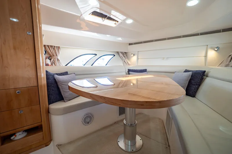  Yacht Photos Pics Luxurious interior of 2018 Intrepid 475 Sport Yacht with elegant seating and wooden table.