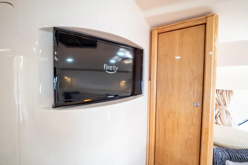  Yacht Photos Pics 2018 Intrepid 475 Sport Yacht interior with Fire TV and wooden cabinet.