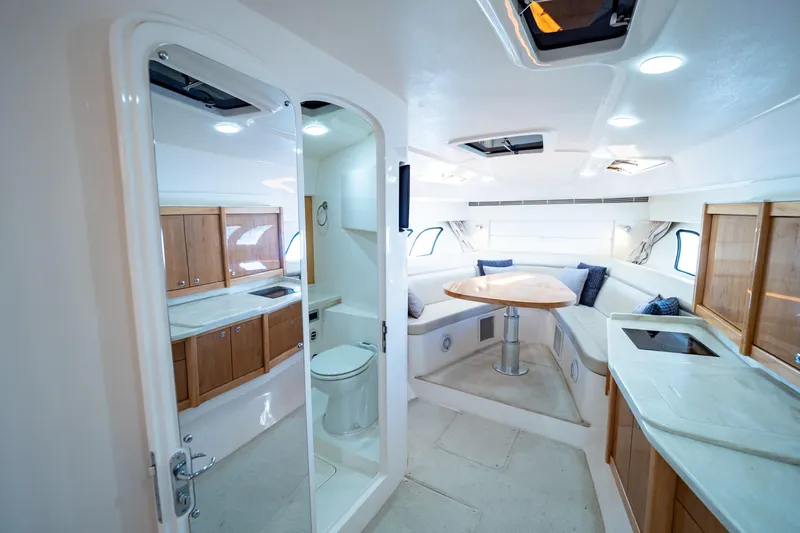  Yacht Photos Pics Luxurious interior of 2018 Intrepid 475 Sport Yacht with modern kitchen and seating area.