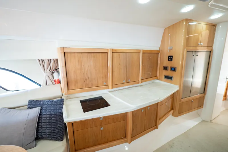  Yacht Photos Pics Luxurious 2018 Intrepid 475 Sport Yacht interior with modern kitchen and wooden cabinetry.