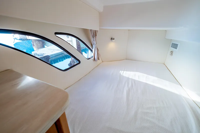  Yacht Photos Pics Interior cabin of 2018 Intrepid 475 Sport Yacht with large windows and cozy bed.