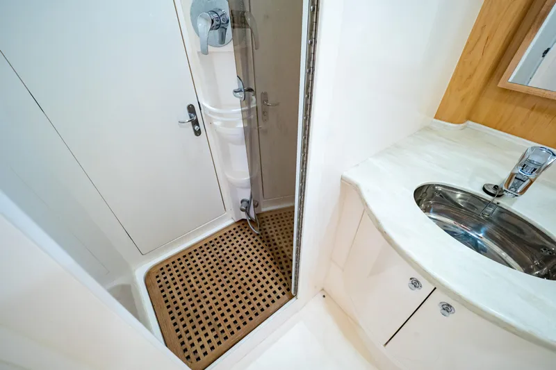  Yacht Photos Pics Bathroom interior of 2018 Intrepid 475 Sport Yacht with shower and sink.