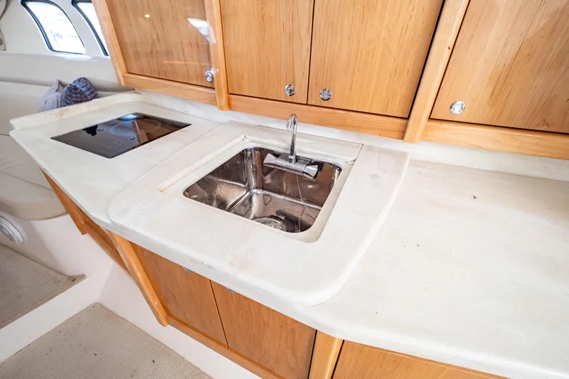  Yacht Photos Pics 2018 Intrepid 475 Sport Yacht interior with sink and wooden cabinets.