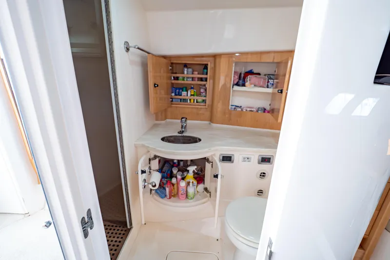  Yacht Photos Pics Bathroom interior of 2018 Intrepid 475 Sport Yacht with sink, storage, and toilet.