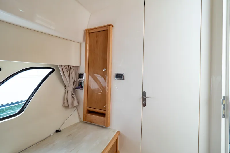  Yacht Photos Pics Interior of 2018 Intrepid 475 Sport Yacht with wooden cabinet and window.