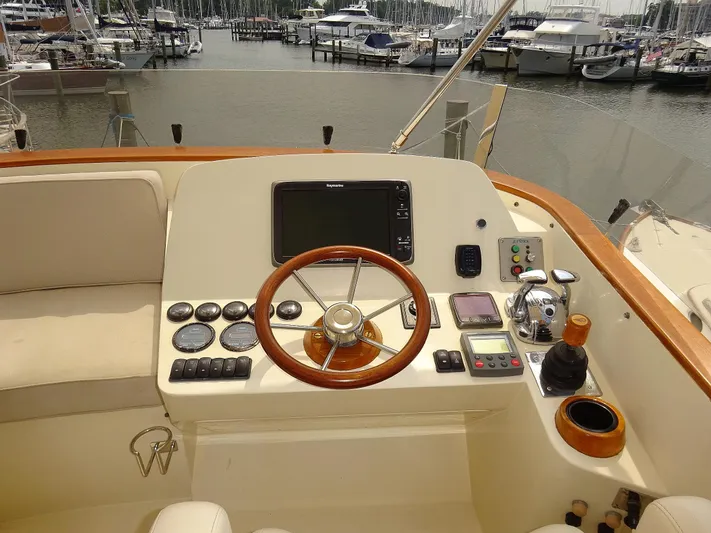 Fine Time Yacht Photos Pics Helm of 2002 Hinckley Talaria 44 FB yacht with wooden steering wheel and navigation controls.