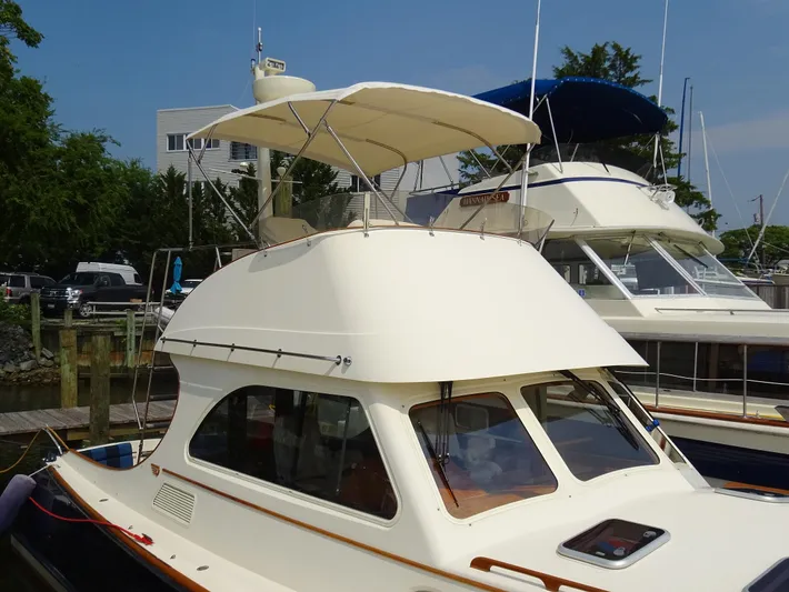 Fine Time Yacht Photos Pics 2002 Hinckley Talaria 44 FB yacht docked, featuring a sleek design and flybridge canopy.