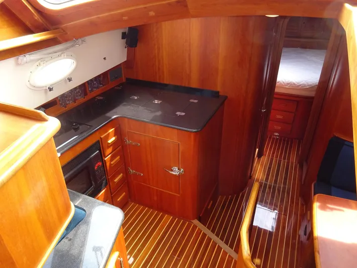 Fine Time Yacht Photos Pics Interior of 2002 Hinckley Talaria 44 FB yacht with wooden cabinetry and flooring.
