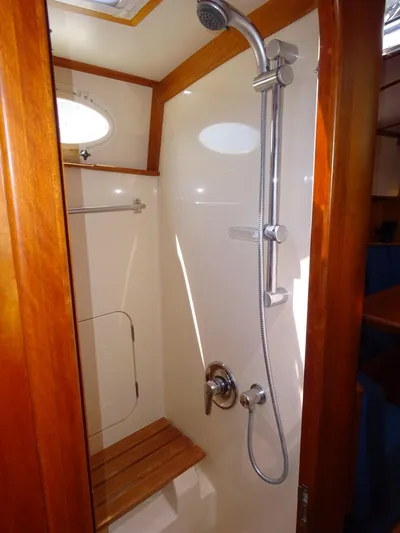 Fine Time Yacht Photos Pics Shower area in 2002 Hinckley Talaria 44 FB yacht with wooden accents and modern fixtures.