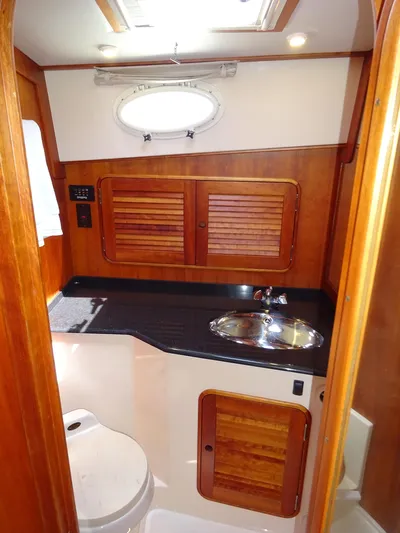 Fine Time Yacht Photos Pics 2002 Hinckley Talaria 44 FB yacht bathroom with wood accents and stainless steel sink.