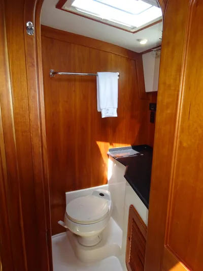 Fine Time Yacht Photos Pics Hinckley Talaria 44 FB 2002 yacht bathroom with wooden interior and skylight.