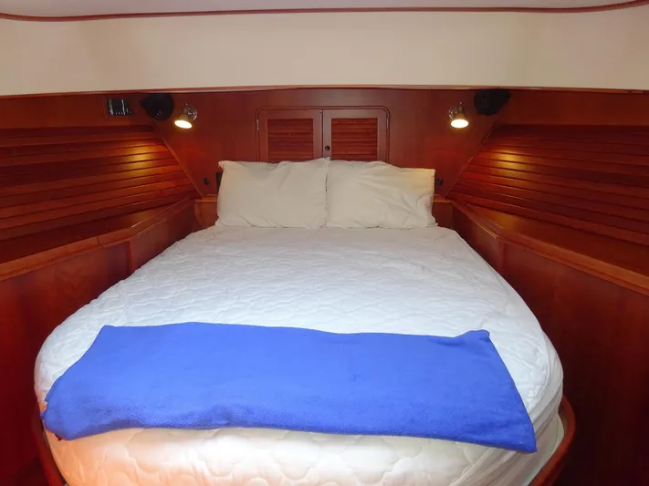 Fine Time Yacht Photos Pics Luxurious cabin interior of 2002 Hinckley Talaria 44 FB with cozy bed and wooden finish.