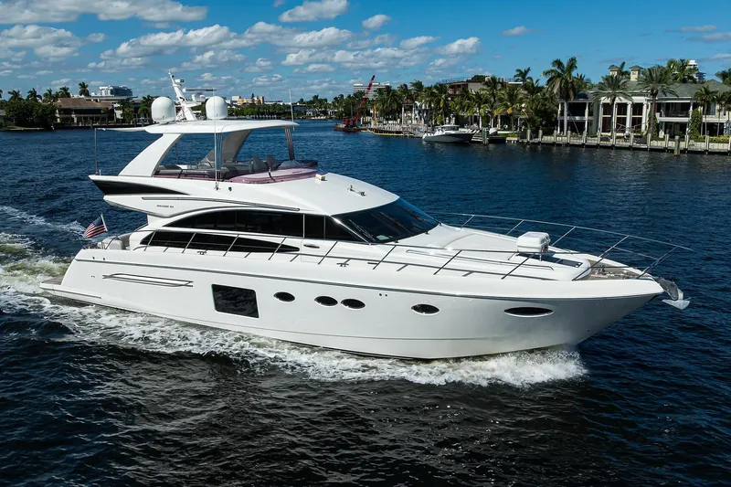 Tight Squeeze Yacht Photos Pics Luxurious 2016 Princess F64 yacht cruising on a sunny day, surrounded by waterfront homes.