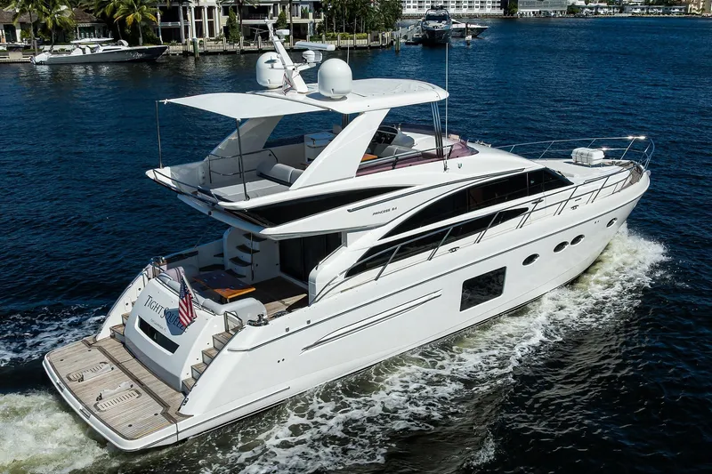 Tight Squeeze Yacht Photos Pics Luxurious 2016 Princess F64 yacht cruising on a serene waterway.