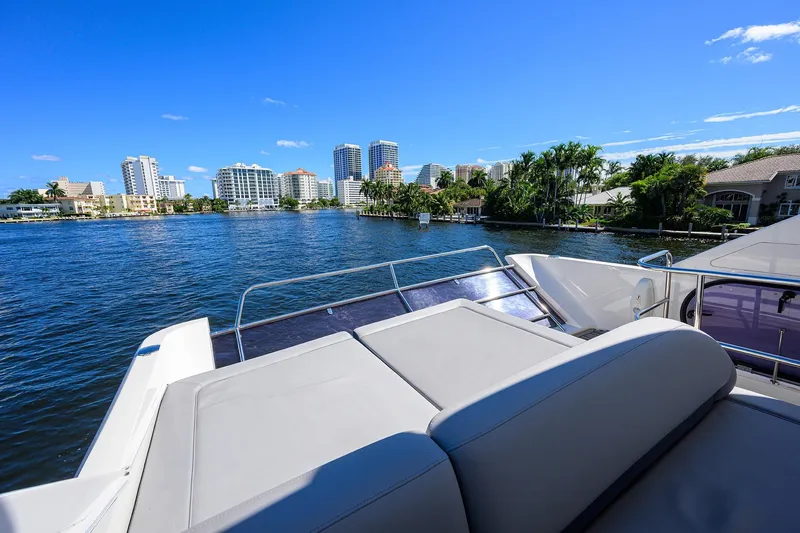 Tight Squeeze Yacht Photos Pics Luxurious 2016 Princess F64 yacht on a scenic waterfront with city skyline.