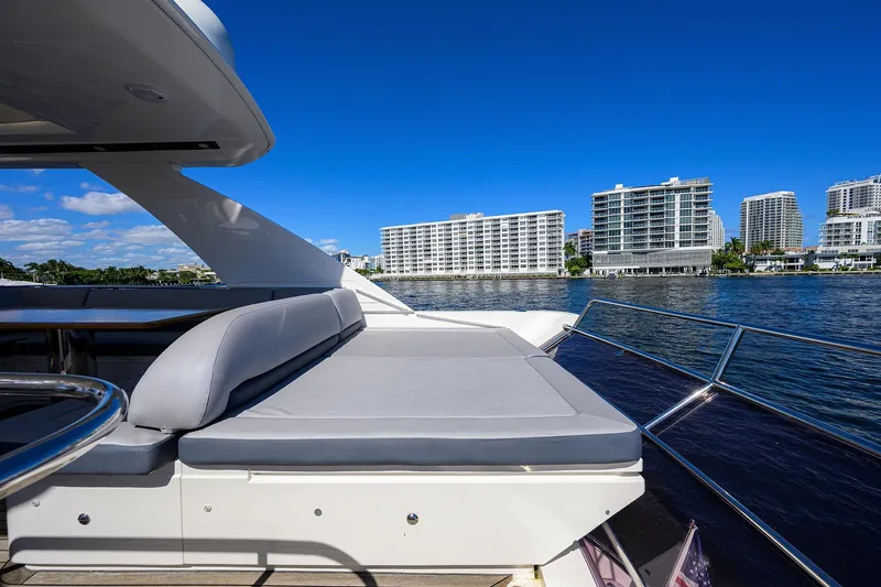 Tight Squeeze Yacht Photos Pics Luxurious 2016 Princess F64 yacht with spacious deck, overlooking waterfront cityscape.