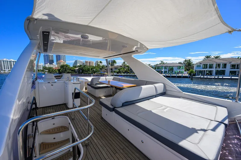Tight Squeeze Yacht Photos Pics Luxurious 2016 Princess F64 yacht deck with seating, overlooking waterfront homes and city skyline.