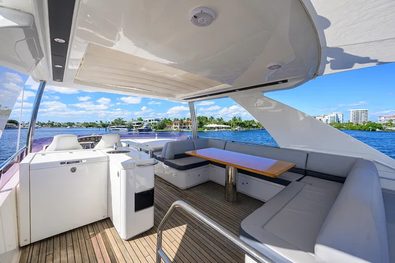 Tight Squeeze Yacht Photos Pics Luxurious 2016 Princess F64 yacht interior with seating and scenic waterfront view.