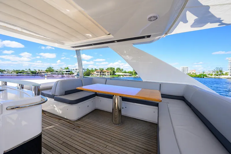 Tight Squeeze Yacht Photos Pics Luxurious 2016 Princess F64 yacht deck with seating, table, and scenic waterfront view.