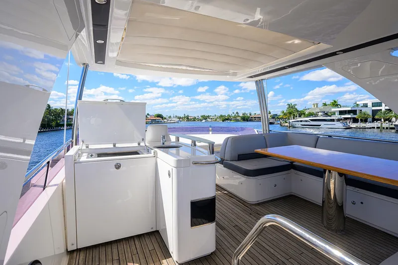 Tight Squeeze Yacht Photos Pics Luxurious 2016 Princess F64 yacht deck with seating, table, and waterfront view.