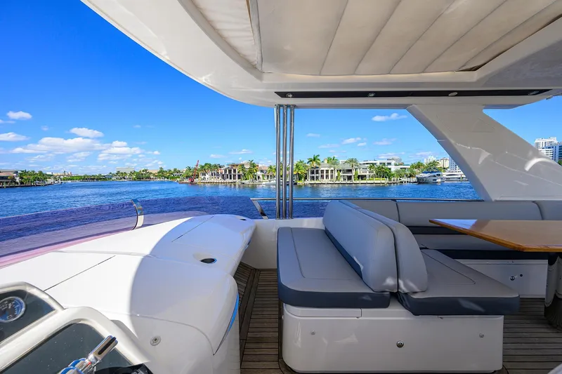 Tight Squeeze Yacht Photos Pics Luxurious 2016 Princess F64 yacht interior with waterfront view, featuring comfortable seating and elegant design.