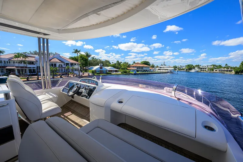 Tight Squeeze Yacht Photos Pics Luxurious 2016 Princess F64 yacht helm with waterfront view and clear blue sky.