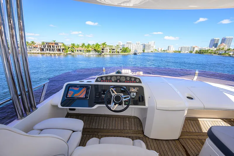 Tight Squeeze Yacht Photos Pics Luxurious 2016 Princess F64 yacht helm with waterfront cityscape view.