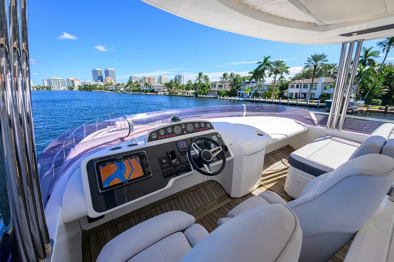 Tight Squeeze Yacht Photos Pics Luxurious 2016 Princess F64 yacht interior with modern helm, overlooking scenic waterfront views.